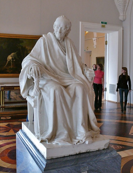 Вольтер в кресле, Жан-Антуан Гудон 1781 г. Мрамор. Высота. 138 см. Государственный Эрмитаж. Мраморная статуя Вольтера была куплена Екатериной II у автора в 1784 году. Сидящий в кресле Вольтер -